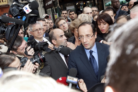   Francois Hollande meets journalists and residents of 18 district of Paris. Marché Ornano. Paris. 11 october 2011.
