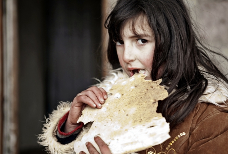  An armenian girl Arevik tastes a fresh-backed armenian lavash. Armenia. March. 2010.